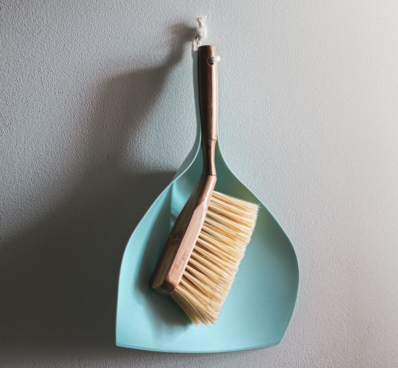brown wooden brush on white wall